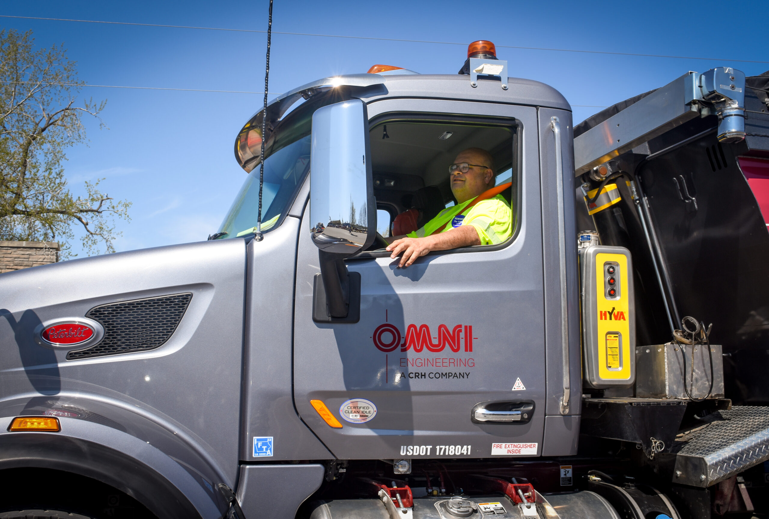 OMNI Engineering employee driving an asphalt truck.