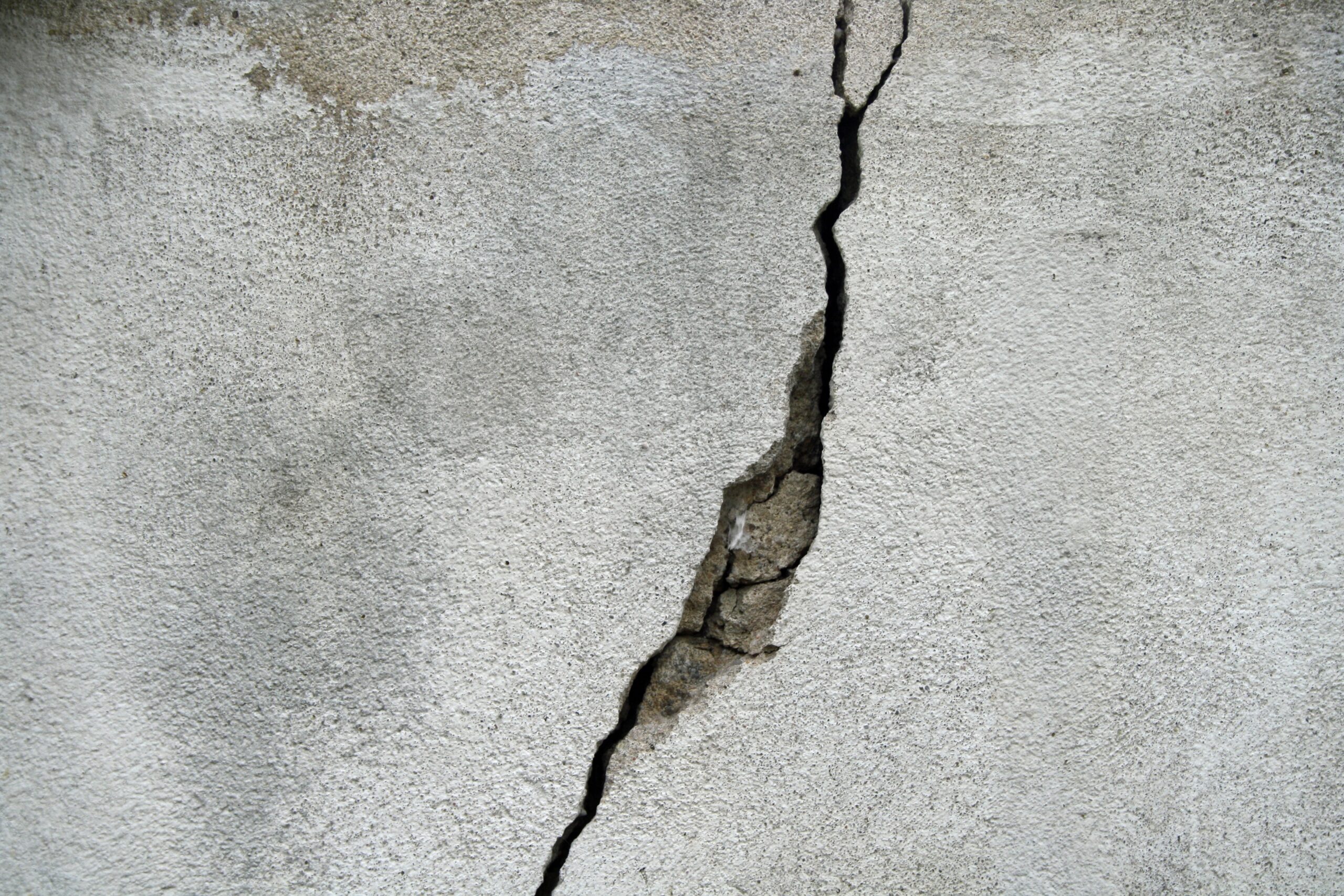 Cracked concrete surface showing damage from warm weather conditions and improper curing